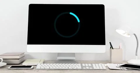 Image of loading circle on computer in office 库存插图