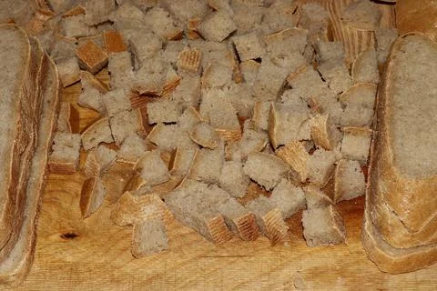 Image of a loaf of bread cut into slices on a kitchen board. Stock Photos