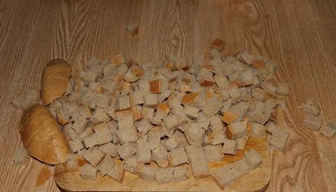 Image of a loaf of bread cut into slices on a kitchen board Stock Photos