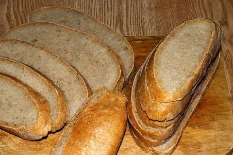 Image of a loaf of bread cut into slices on a kitchen board. bread Stock Photos