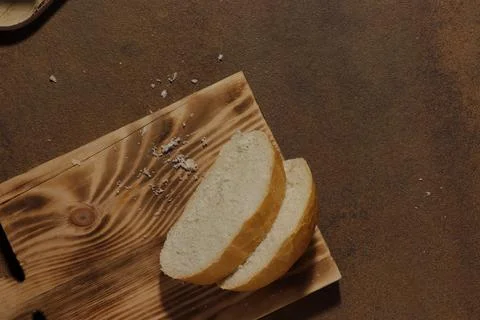 Image of a loaf of bread cut into slices on a kitchen board Stock Photos