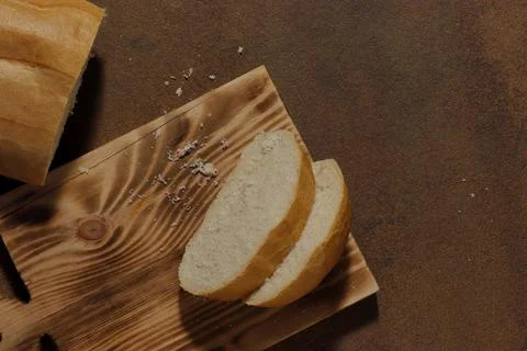 Image of a loaf of bread cut into slices on a kitchen board Stock Photos