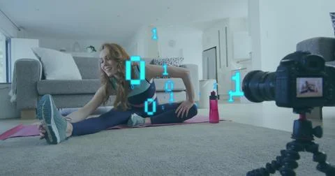 Image of looping binary codes, caucasian woman recordings stretching exercise on Foto stock