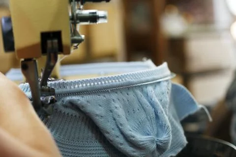 Image of machine knitting blue children's cap Stock Photos