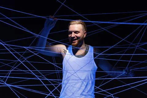 Image of mad man tangled in threads in neon light Stock Photos