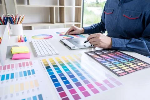 Image of male creative graphic designer working on color selection and drawin Stock Photos
