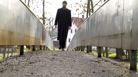 Image of man crossing small bridge at countryside, Heuchlingen, Germany. Stock Footage 102646182