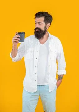 Image of man has coffee break isolated on yellow background Stock Photos
