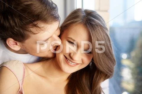 Image of man kissing his girlfriend Stock Photos
