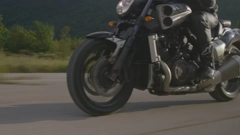 Image of man riding a powerful motorcycle at an abandoned airfield. Stock Footage 151859649