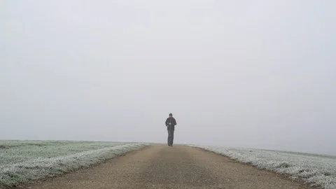 Image of man running on countryside road taken by mist, Heuchlingen, Germany. Video stock 102647774