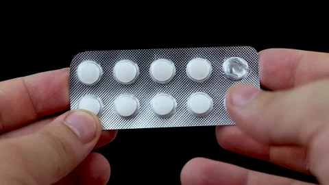Image of man taking pill out from blister pack at home. We take the tablets with 스톡 동영상 90964099