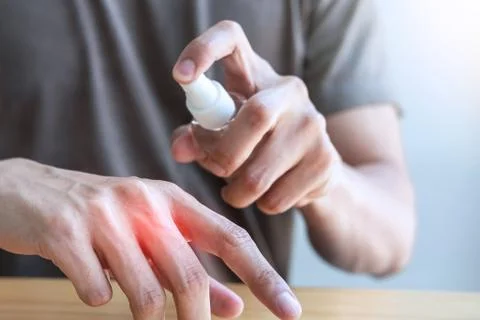 Image of Man using alcohol spray to hands washing with eliminate bacteria and Stock Photos