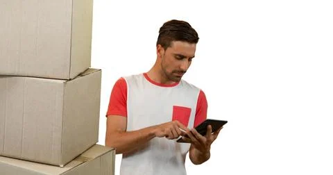 Image of man using tablet with stacks of boxes on white background Stock Photos