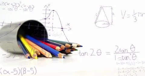Image of mathematical equations floating over colored pencils against white Foto stock