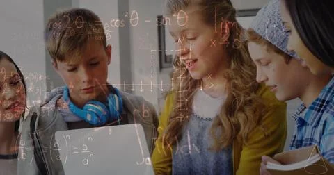 Image of mathematical equations over school children using laptop in classroom 스톡 사진