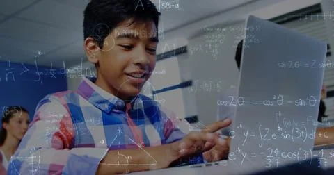 Image of mathematical equations over schoolboy using laptop in classroom 写真素材