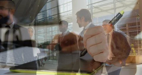 Image of men using computer over diverse group of business people Foto stock