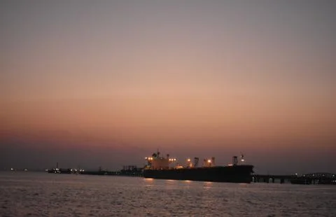 Image of a merchant ship standing far away near Mumbai Stock Photos