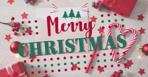 Image of merry christmas text with tree icons and dots over gift box, baubl.. Stock Photos