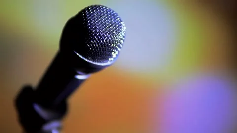 Image of a microphone on a colored background. Stock Footage 130999743