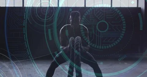 Image of microprocessor connections over man exercising with ropes 写真素材