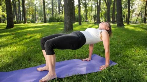 Image of mid aged smiling happy woman meditating and doing yoga exercises on Stock Photos