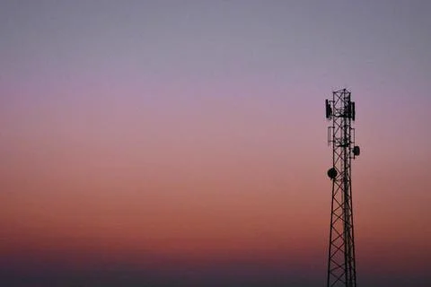 A image of a mobile tower captured during the sunset with reddish sky Stock Photos