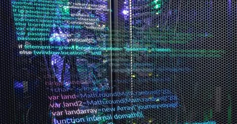 Image of multicolored computer language over illuminated data server system Stockfoto's