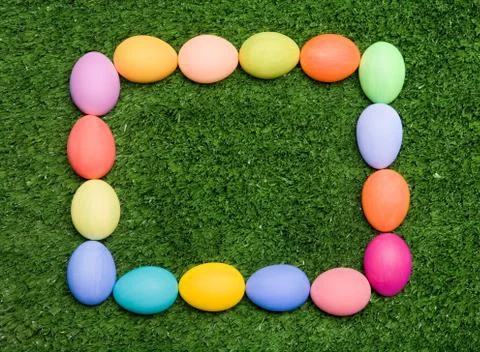 Image of multicolored eggs forming a square over green grass Stock Photos
