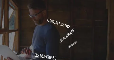 Image of multiple changing numbers over caucasian man standing near window and Stock Illustration