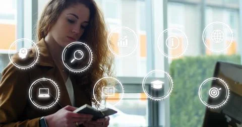 Image of multiple icons in circles over caucasian woman using laptop while Foto stock