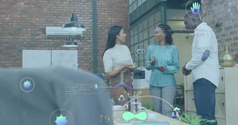 Image of multiple icons over diverse coworkers standing and discussing in office Stock Photos