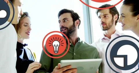 Image of multiple icons over diverse coworkers standing and discussing on Stock Photos