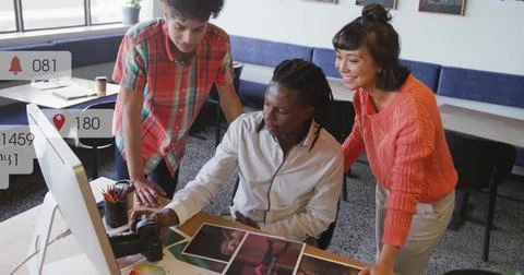 Image of multiple notification bars over diverse coworkers discussing design on Stock Photos