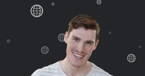 Image of multiple web globe icons floating over caucasian man smiling against Stock Photos