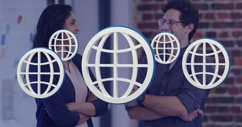 Image of multiple web globe icons floating against diverse man and woman smiling Stock Photos