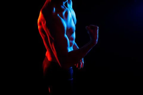 Image of muscle man posing in studio, dark white red background Stock Photos