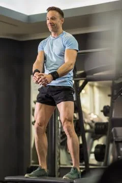 Image of a muscular man doing high knees exercises at the gym. Stock Photos