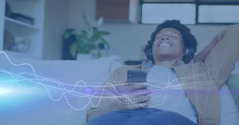 Image of music data processing over african american man with headphones Stock Photos