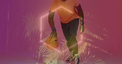 Image of neon pattern and leaves over african american basketball player Stock Photos