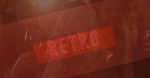 Image of neon retro text in red over smiling friends at party Foto stock
