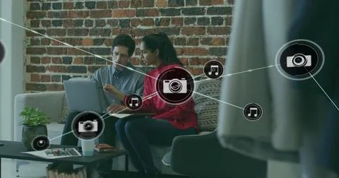 Image of network of connections with camera icons over diverse business people Foto stock
