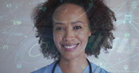 Image of network of connections with icons over biracial woman smiling at camera Stock Photos