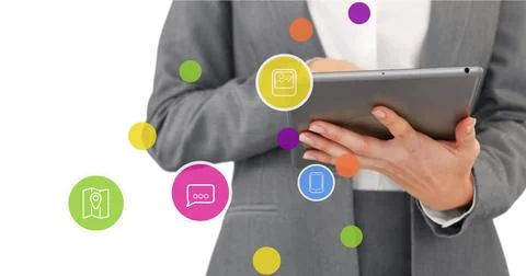 Image of network of connections with icons over businesswoman using tablet Stock Photos