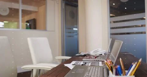 Image of network of icons over desk with laptop Stock Photos