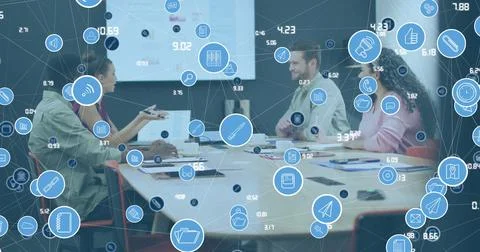 Image of network of icons over diverse colleagues discussing together at office Stock Photos