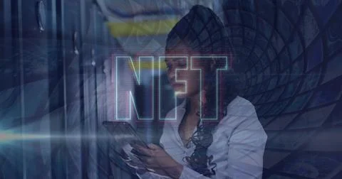 Image of nft text over african american using tablet in server room Stock Photos