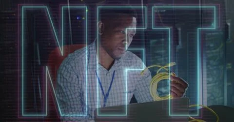 Image of nft text over african american man using laptop in server room 스톡 사진