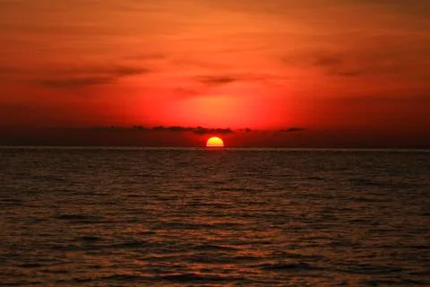 An image of a nice red sunset with a big yellow sun Stock Photos